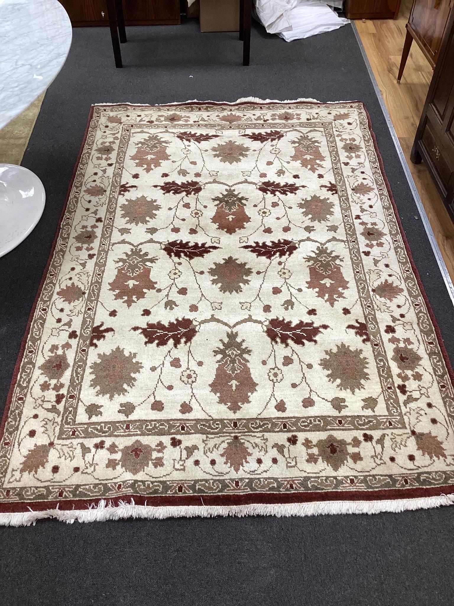 An Arts & Crafts design ivory ground carpet, 240 x 156cm